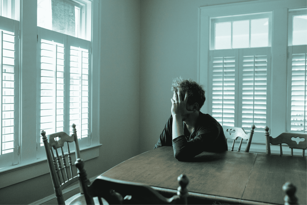 man clutching head with brain fog