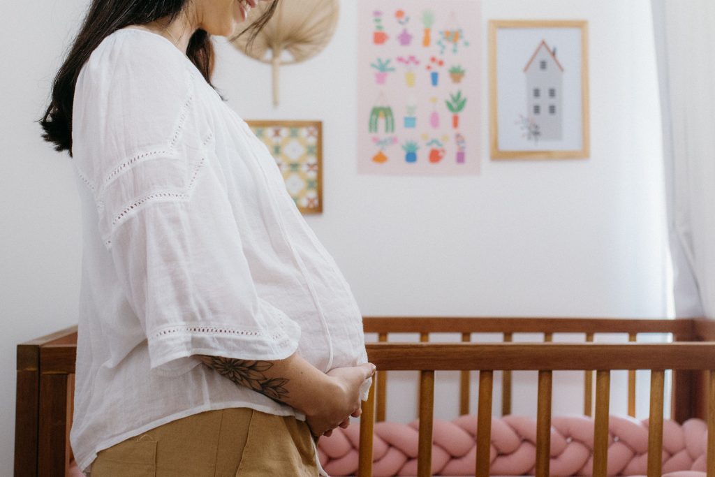 Pregnant woman resting her hands on her belly in south san francisco